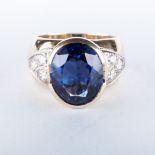A TANZANITE AND DIAMOND RING the 9.09ct oval cut tanzanite is half bezel set and then accentuated