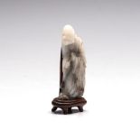 A CHINESE CELADON JADE CARVING OF A SAGE, LATE 19TH/EARLY 20TH CENTURY carved in profile, the
