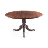A REGENCY MAHOGANY CENTRE TABLE the moulded circular tilt-top above a gadrooned turned column,