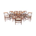 A SET OF TWELVE REGENCY MAHOGANY DINING CHAIRS each armchair with a curved crossbanded top rail,