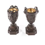 A PAIR OF BRONZE FRENCH FIRST EMPIRE BRASS LINE CAMPANA URNS each urn surmounted with rams head