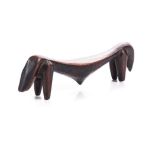A HEADREST, NGONI, ZAMBIA carved as an elongated bull echoing the proportions and subject of a