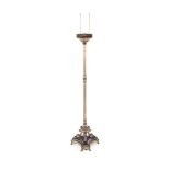 A BRASS STANDING LAMP the reeded column surmounted by an acanthus leaf and pierced collar, on an