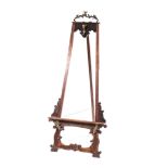 A FRENCH WALNUT EASEL, 19TH CENTURY surmounted by a gilt-metal oak leaf cresting, on scrolling and