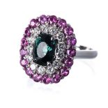 A GREEN TOURMALINE, PINK SAPPHIRE AND DIAMOND RING centred with a claw-set cushion-cut green