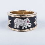 A BLACK ENAMEL AND DIAMOND ELEPHANT RING the elephant pavéd with white diamonds and a ruby fashioned