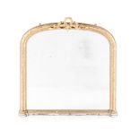 A GILTWOOD OVER MANTEL MIRROR the arched plate within a conforming frame, surmounted and centred