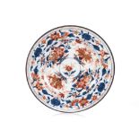A CHINESE IMARI PLATE, QING DYNASTY, QIANLONG, 1736 – 1795 the centre painted with a single bloom