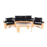 A SWEDISH KROKEN LEATHER LOUNGE SUITE comprising: a three seater settee and two chairs, each