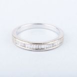 A BAGUETTE HALF ETERNITY RING the channel set baguettes colour G/H, clarity VS/SI weigh