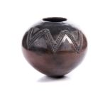 A CLAY BEER POT (UKHAMBA), ZULU raku firing still evident, with fine engraved and raised