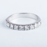 A PLATINUM HALF ETERNITY RING the nine round brilliant cut diamonds weigh approximately 1ct and