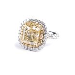 A FANCY YELLOW DIAMOND RING the modified brilliant cut-cornered rectangular cut diamond weighing 6.