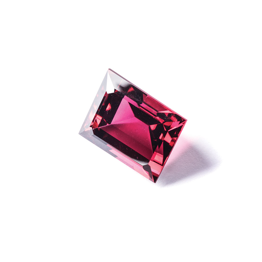 A 31.00CT RUBELITE TOURMALINE the rectangular cut rubelite tourmaline is deep pink in colour