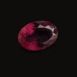 A 18.93CT TOURMALINE the oval mixed cut rubelite tourmaline is medium dark in intensity and