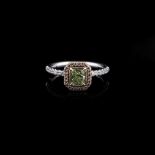 A YELLOW-GREEN DIAMOND RING the 0,65cts modified brilliant cut-cornered rectangular cut diamond is