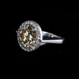 A DIAMOND RING the 7.97ct round brilliant cut diamond, natural, fancy, brownish yellow in colour