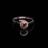 A VIVID FANCY BROWNISH ORANGE DIAMOND RING the 0.4370cts round brilliant cut diamond, clarity SI2 is