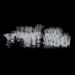 A SUITE OF MOULDED GLASSES, 20TH CENTURY comprising: 10 champagne flutes, 8 red wine glasses, 16