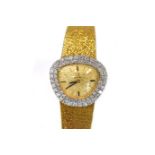 A LADIES 18CT GOLD WRISTWATCH, OMEGA the oval gilt dial applied with black baton hour markers, the