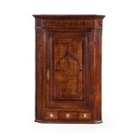 A GEORGE III OAK HANGING CORNER CUPBOARD