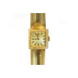 A LADIES 18CT GOLD WRISTWATCH, ROLEX PRECISION the square silvered dial applied with black baton
