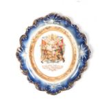 A LUSTREWARE PLAQUE COMMEMORATING PEACE, JUNE 1ST 1902 of oval form with a blue glazed moulded