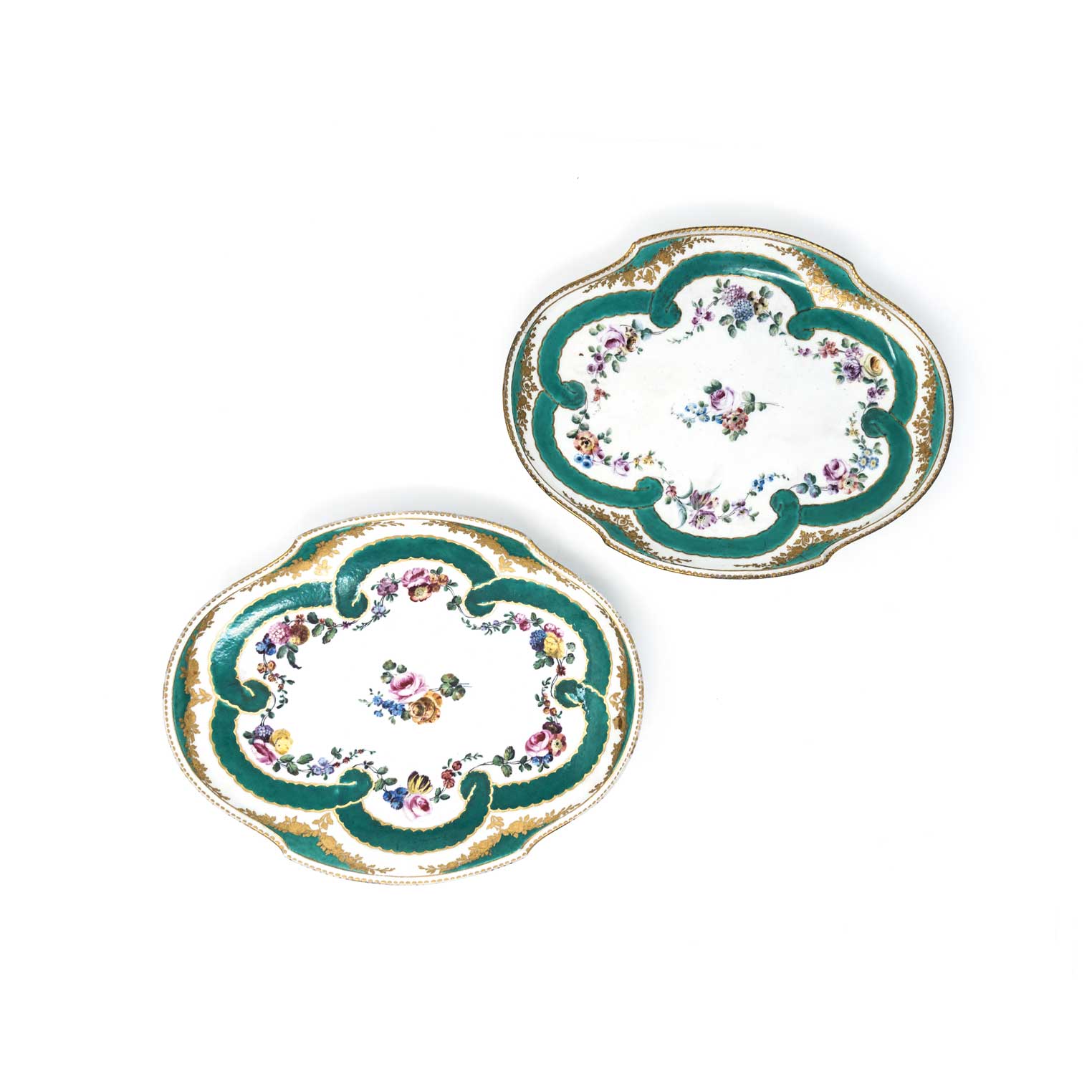 A NEAR PAIR OF SEVRES PLATES, 19TH CENTURY shaped oval with gilt dentil painted rim, painted with