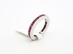 Ruby full eternity ring, calibre cut rubies set to the full hoop, mounted in white metal, ring