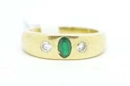 Gentlemen's three stone emerald and diamond ring, central oval cut emerald with a round brilliant