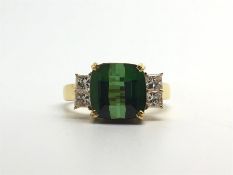 Green tourmaline and diamond ring, fancy mixed cut green tourmaline set with two princess cut