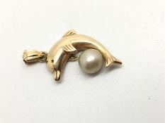 9ct yellow gold dolphin pendant, set with a pearl