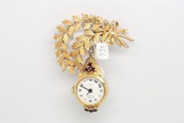 A 9ct yellow gold Rotary fob watch, with six garnets, suspended from a yellow gold feather brooch