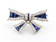 Sapphire and diamond bow brooch, round cut diamonds with calibre cut sapphires, 38mm x 25mm, mounted