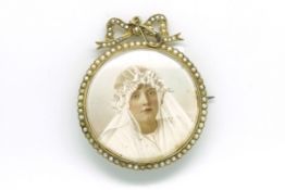 Miniature painted portrait pendant/brooch depicting a bride painted on ivory, surrounded by seed