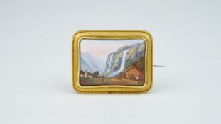 Swiss enamel landscape brooch, depicting a church and a cabin, with a waterfall and mountains in the