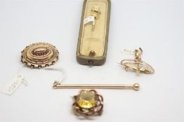 Five yellow metal brooches, including a citrine brooch stamped 9ct, a Victorian locket brooch tested