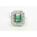 Emerald and diamond cluster ring, central step cut emerald weighing an estimated 2.25ct,
