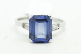 Synthetic sapphire and diamond ring, emerald cut sapphire with baguette cut diamond shoulders, set