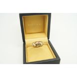 Bulgari ring, round cut rubies, set in zig-zag lines, spaced in a similarly designed gold band,
