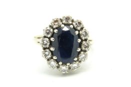 Sapphire and diamond cluster ring, central oval cut sapphire measuring 12.3 x 8.35 x 5.07mm,