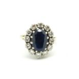 Sapphire and diamond cluster ring, central oval cut sapphire measuring 12.3 x 8.35 x 5.07mm,