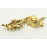 Pair of yellow metal earrings, designed as textured leaves, tested as 18ct, with post and clip
