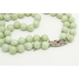 Two row jade bead necklace, beads measure an estimated 9mm, on a ruby and diamond set clasp