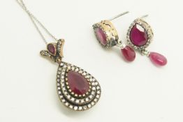 Ruby and paste pendant, set with a central pear cut ruby with a double surround of paste stones, set