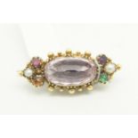 Gem set brooch, central oval cut foil backed stone with beaded surround, pearls and gems set to each