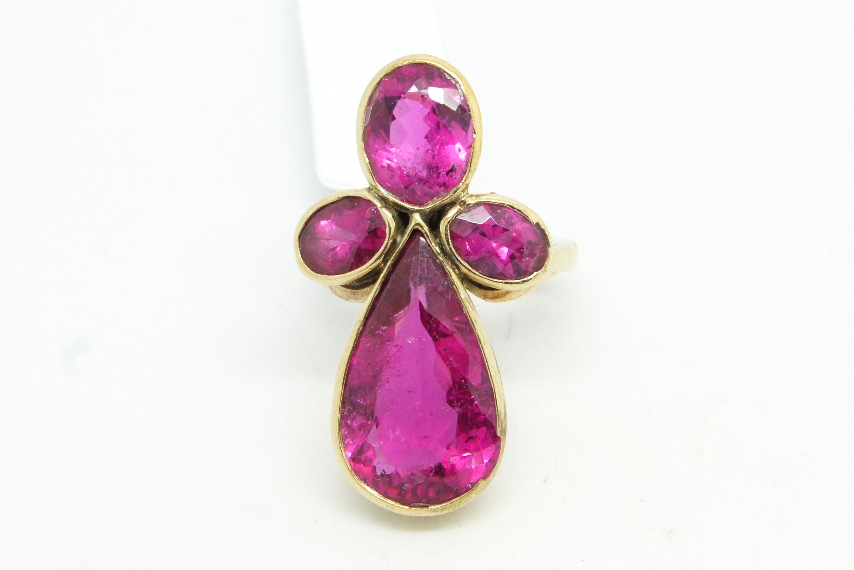 Pink tourmaline dress ring, set with four pink tourmalines, one large pear cut and three oval