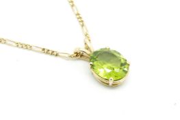 A single stone peridot pendant, oval cut peridot measuring 11.5 x 9.4mm, mounted in 9ct yellow