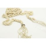 Twisted seed pearl lariat style necklace, each end is terminated by seed pearl tassels, suspended