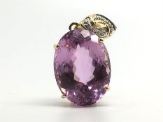 Patroke kunzite and diamond pendant, 31ct oval pink kunzite, on a diamond set bail, hallmarked